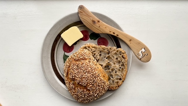 sesame sourdough roll with butter